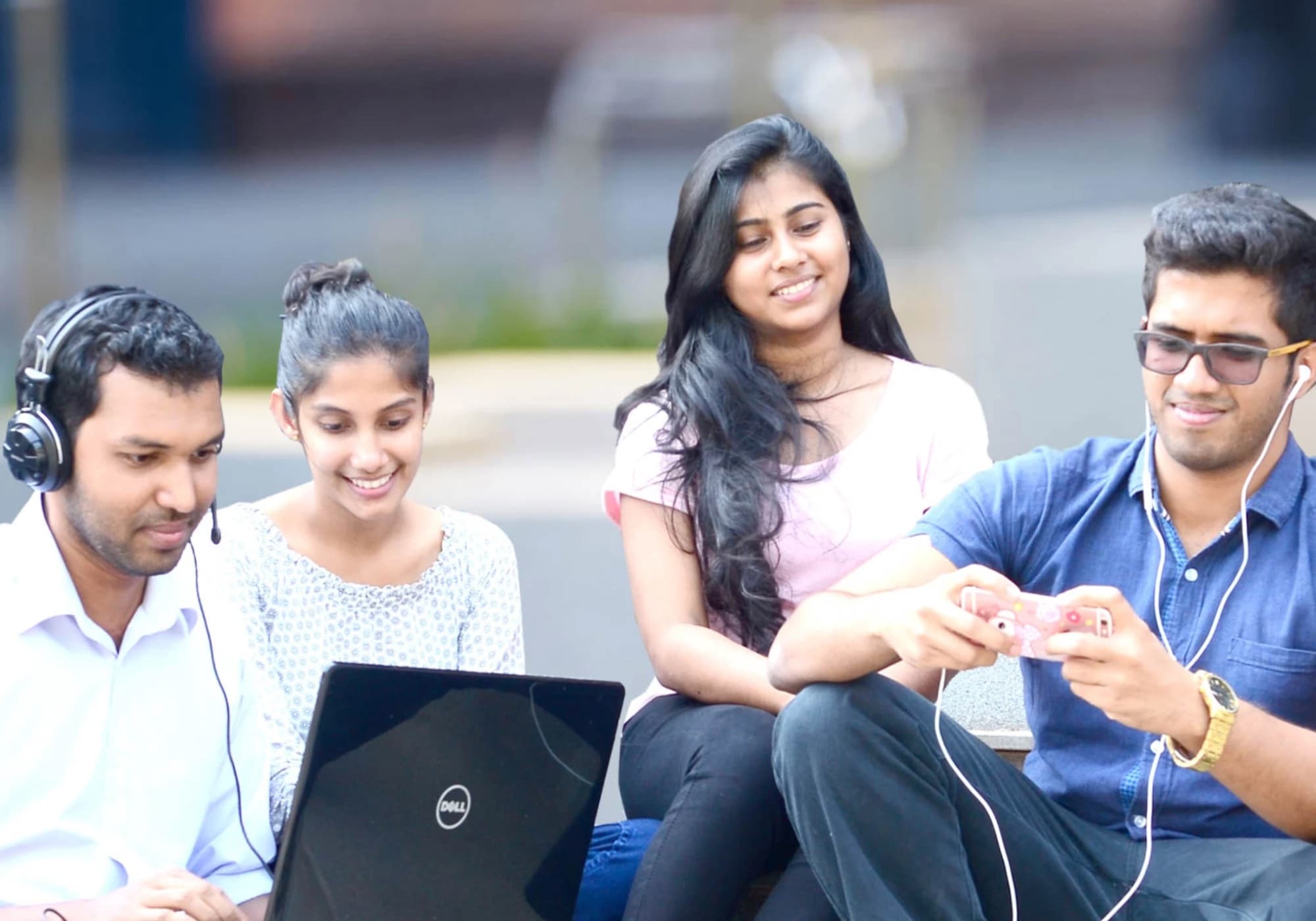 University students learning together on a laptop and phone